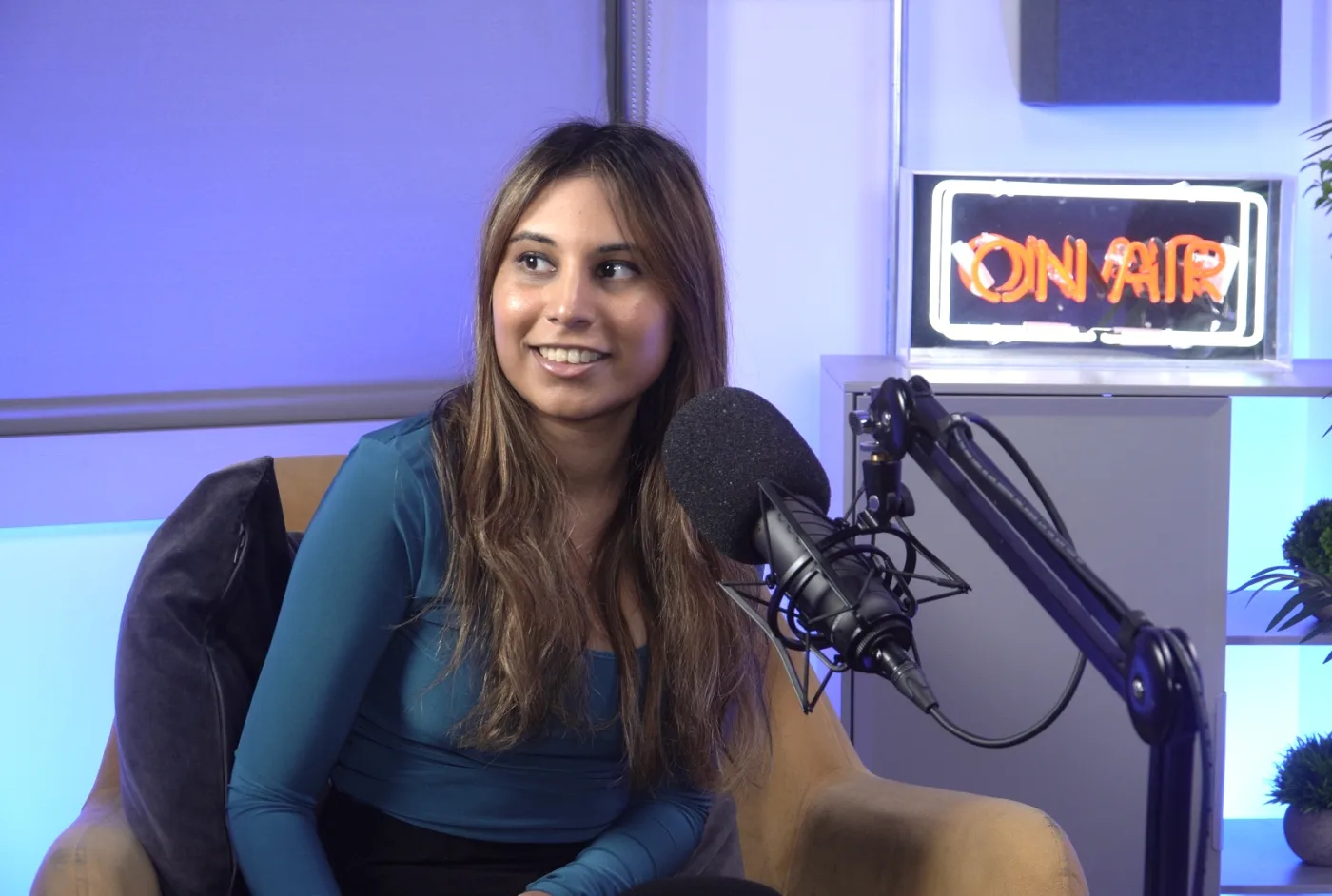 Nadiyah Rajabally recording in the Novaa Solutions podcast studio under an On Air sign